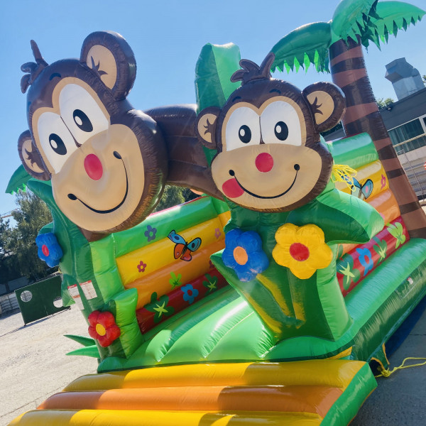 Knalliges grün, gelb und orange sind die Farben unserer Hüpfburg Affen-Safari: Mieten für Ihr Fest!